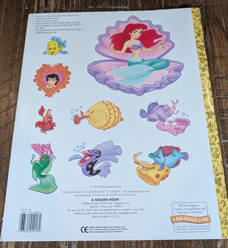 May include: Back cover of a Golden Book featuring Disney's The Little Mermaid. The cover displays Ariel in a seashell, along with other characters like Flounder and Sebastian. The book is from 1997.