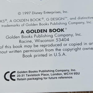May include: Close-up of a white background with text from a Golden Book. The text includes the copyright information for Disney Enterprises, Inc. and the Golden Books Publishing Company, Inc. The text also includes the address of the Golden Books Publishing Company, Inc. in Racine, Wisconsin.