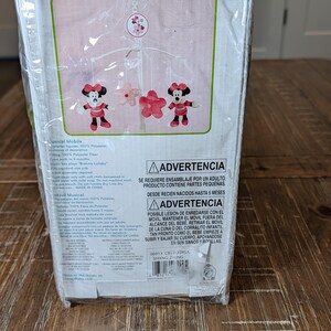 May include: A Disney baby musical mobile in a clear plastic package. The box features the text "Sitting Pretty Musical Mobile" and "Sweeter dreams for your sleeping baby." The mobile has Minnie Mouse and flower figures.