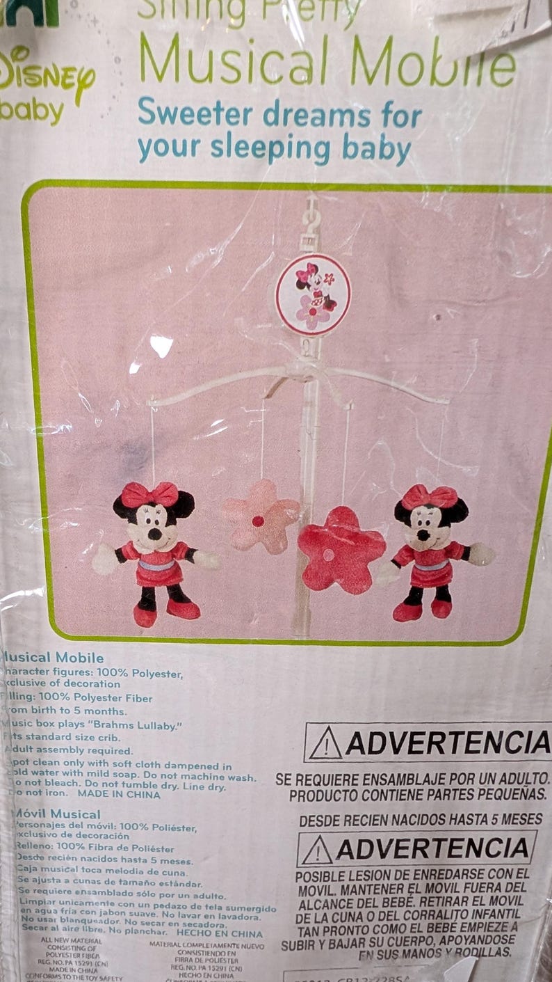 May include: A Disney baby musical mobile featuring Minnie Mouse figures and pink flower accents. The mobile plays "Brahms Lullaby" and is designed for cribs. The packaging includes the text "Sweeter dreams for your sleeping baby."