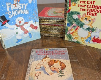 May include: A collection of Little Golden Books including Frosty the Snowman, The Cat That Climbed the Christmas Tree, and The Poky Little Puppy's Wonderful Winter Day. The books feature colorful illustrations of a snowman, a cat, and a puppy.