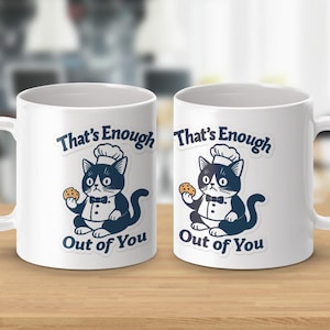 May include: Two white ceramic mugs with a cartoon cat design. The cat, wearing a chef's hat and bow tie, holds a cookie. Text on the mug reads "That's Enough Out of You."