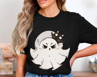 May include: Black t-shirt featuring a Halloween-themed graphic. The design includes a white ghost with an angry expression, a black cat, and a full moon. The graphic is centered on the shirt, creating a fun and festive look.