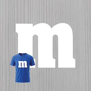 May include: A short-sleeved blue t-shirt featuring a large white lowercase letter m printed on the chest. The shirt has a crew neckline and a standard fit. A large white letter m is also displayed in the background behind the blue t-shirt.