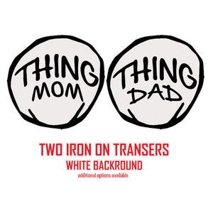 May include: Two iron-on transfers with white backgrounds. The transfers feature the words "Thing Mom" and "Thing Dad" in a hand-drawn style.