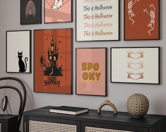 May include: A gallery wall set of eight framed prints featuring Halloween themes including a ghost, a black cat, a haunted castle, skeletons, and text reading This is Halloween and SPOOKY, displayed in various sizes with black and white frames.