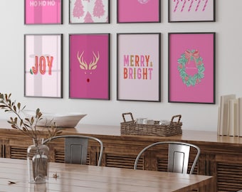 May include: A gallery wall of eight framed prints featuring pink and red holiday themes. The art includes text like HO HO HO, JOY, and MERRY & BRIGHT, alongside illustrations of Christmas trees, a bauble, candy canes, a reindeer, and a wreath.