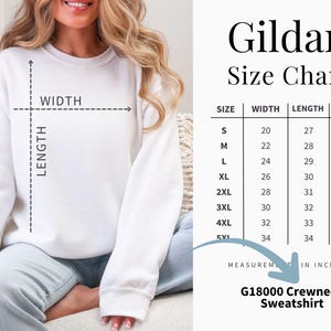 May include: A white crewneck sweatshirt with a Gildan size chart displaying width, length, and sleeve measurements in inches. The chart lists sizes from S to 5XL with corresponding numerical values for each dimension, labeled G18000 Crewneck Sweatshirt.