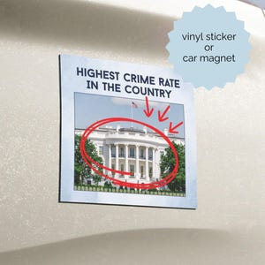 May include: A square vinyl sticker or car magnet featuring a photograph of the White House with a red hand-drawn circle around the building and three red arrows pointing toward it. The text HIGHEST CRIME RATE IN THE COUNTRY is printed above.