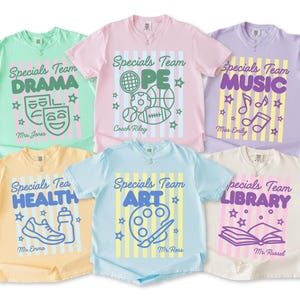 May include: Six short-sleeve t-shirts in pastel colors featuring vertical stripes and the text Specials Team. Each shirt displays a unique subject: Drama, PE, Music, Health, Art, or Library, along with corresponding graphic icons and teacher names.