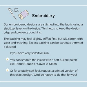 May include: An informational graphic on a light blue background titled Embroidery, featuring a needle and thread icon. It explains that designs are stitched with a stabilizer layer, notes the backing may feel stiff, and suggests using a soft fusible patch or requesting a printed version for sensitive skin.