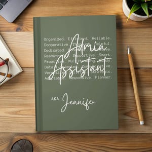 May include: A green notebook with the words "Admin Assistant" in white script. The notebook also includes the name "Jennifer" and a list of descriptive words such as "Organized," "Efficient," and "Reliable."