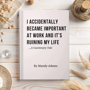 May include: A rectangular book with a light pink cover featuring black text that reads I ACCIDENTALLY BECAME IMPORTANT AT WORK AND IT'S RUINING MY LIFE ...A Cautionary Tale By Mandy Adams. The book is positioned on a light wood surface.