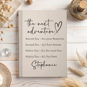 May include: A beige journal with the words "the next adventure" and a heart symbol in black script. Below, inspirational text reads "Behind You - All your Memories," and more. The name "Stephanie" is written at the bottom.