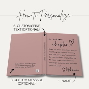 May include: Open book with a dusty rose cover, displaying the text "a new chapter" and a heart symbol. The right page features a personalized message and signature. The left page has text that says "Dedication, Special Note, or Whatever Message You Would Like to Put Here."