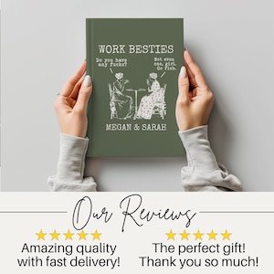 May include: A dark olive green hardcover book with white text that reads WORK BESTIES, MEGAN & SARAH, and dialogue bubbles stating Do you have any fucks? and Not even one, girl. Go fish. above a line drawing of two people sitting at a table.