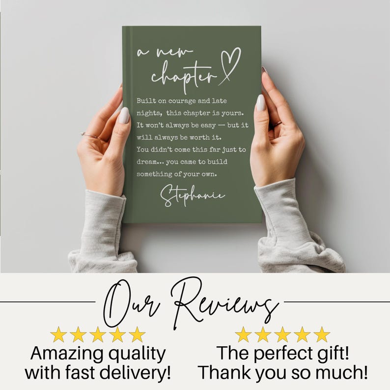 May include: A green journal with the words "a new chapter" and a heart symbol in white script. The journal has inspirational text and the name "Stephanie" at the bottom. The journal is held by a person.