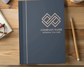 May include: A dark blue notebook with a rose gold vertical stripe and logo. The logo is geometric and the text reads "COMPANY NAME OPTIONAL TAG LINE". The words "FULLY CUSTOMIZABLE" are at the bottom.