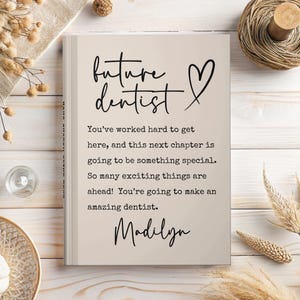 May include: A beige book with the words "future dentist" and a heart symbol in black script. The book contains encouraging text about becoming a dentist and is personalized with the name "Madilyn".