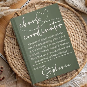 May include: A green notebook with a white stitched heart and the text "chaos coordinator" with a definition. The text "See also: Stephanie" is at the bottom of the notebook.