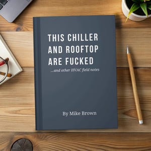 May include: A dark blue book with the title "THIS CHILLER AND ROOFTOP ARE FUCKED" and the subtitle "...and other HVAC field notes." The author's name, "By Mike Brown," is at the bottom. The book is on a wooden surface.