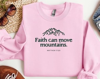 May include: Pink sweatshirt with a mountain graphic and the text "Faith can move mountains. Matthew 17:20"