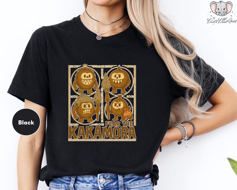 a woman wearing a black shirt with a picture of two pumpkins on it