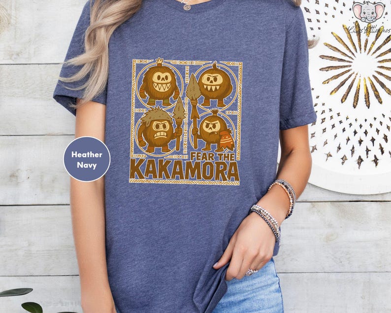 a woman wearing a blue t - shirt with a picture of two monkeys on it