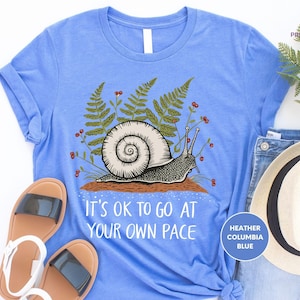 a blue shirt with a snail on it