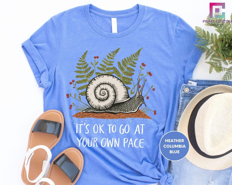 a blue shirt with a snail on it