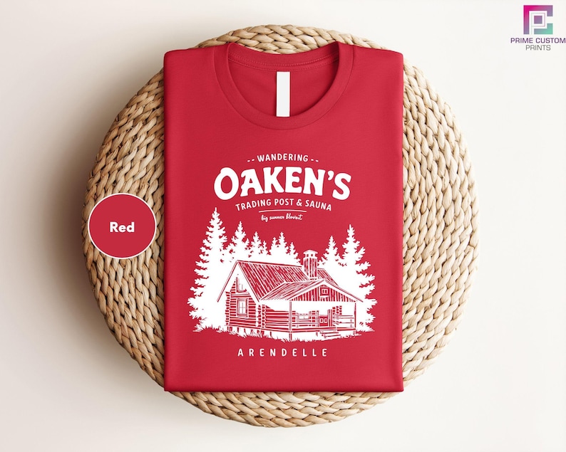 a red t - shirt with a picture of a cabin on it