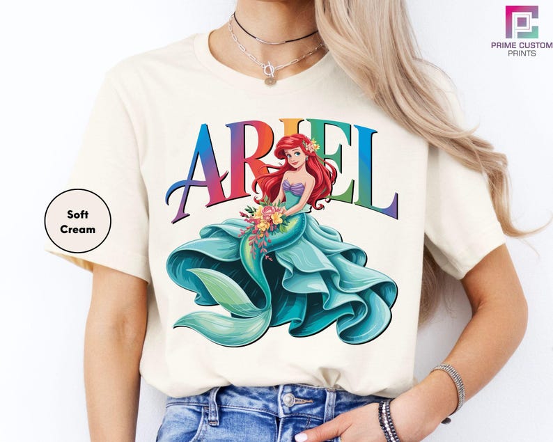a woman wearing a white ariel t - shirt with the word ariel on it