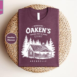 a t - shirt with a picture of a cabin on it