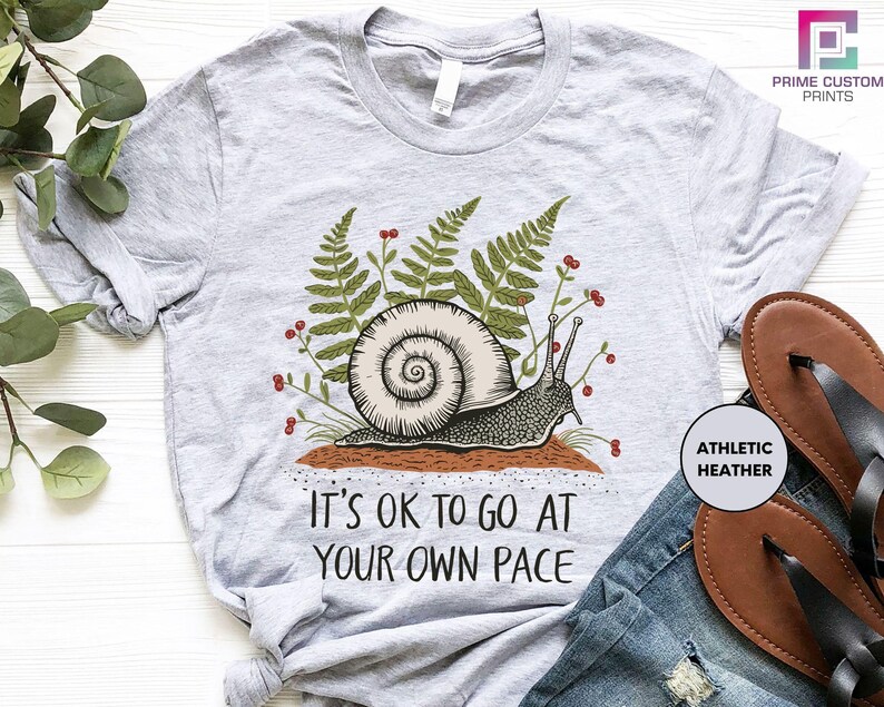 a t - shirt that says it's ok to go at your own pace