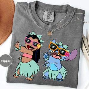a couple of cartoon characters on a gray shirt