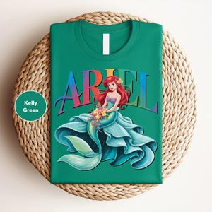 a green ariel t - shirt sitting on top of a wicker basket