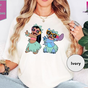 a woman wearing a white shirt with cartoon characters on it