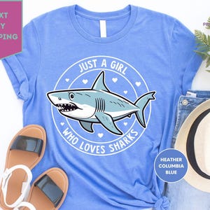 a blue shirt with a shark on it