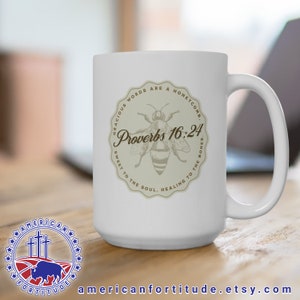 May include: White ceramic mug with a brown graphic of a bee and the text "Gracious words are a honeycomb. Proverbs 16:24. Sweet to the soul, healing to the bones."