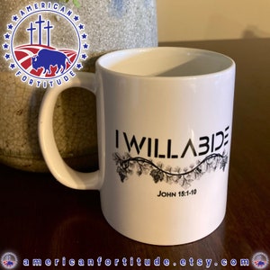 May include: White ceramic mug with a black design that says "I Will Abide" with a vine and grapes design and the text "John 15:1-10" below.