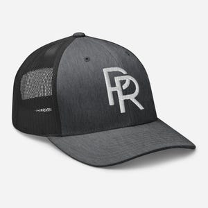 May include: A gray and black trucker hat with a white embroidered "FR" logo on the front. The hat features a mesh back for breathability and a curved brim. The hat is a stylish accessory.