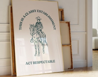 May include: A framed print with a white background and a green illustration of a cowboy riding a horse. The text "This is a Classy Establishment Act Respectable" is printed in green.