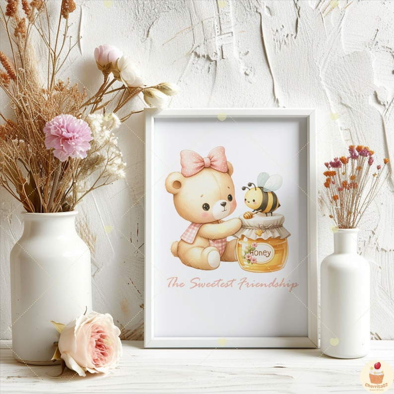 May include: A white frame with a pink and yellow illustration of a teddy bear holding a jar of honey with a bee on top. The text "The Sweetest Friendships" is below the illustration.