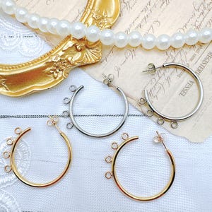 May include: Three pairs of hoop earrings with multiple jump rings. The earrings are silver, gold, and rose gold.