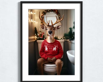 May include: A framed print featuring a deer wearing a red Christmas sweater with white reindeer designs, sitting on a toilet in a bathroom. The bathroom is decorated with Christmas lights and a wreath. The print is labeled "Artistic Ease Prints".