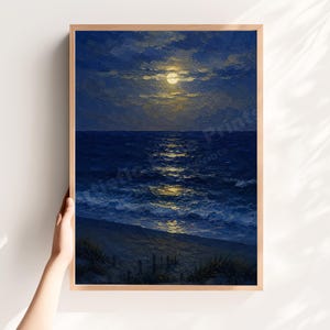 May include: A vertical framed wall art print featuring an oil painting of a moonlit ocean scene at night. The artwork displays a bright full moon glowing through dark blue clouds, casting a shimmering yellow reflection across the deep blue sea waves.
