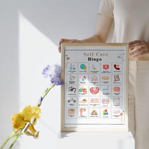 May include: A printable self-care bingo card with a white background and colorful illustrations. The card has 25 squares with different self-care activities, such as taking a bath, listening to music, and reading a book. The title of the card is "Self Care Bingo".