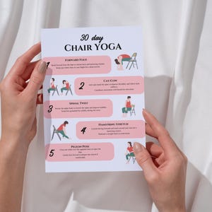 May include: A pink and white printable guide with illustrations of five chair yoga poses. The poses are labeled: Forward Fold, Cat/Cow, Spinal Twist, Hamstring Stretch, and Pigeon Pose. The guide is titled "30 Day Chair Yoga".