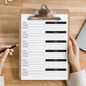 May include: A clipboard with a printed "Electronic Devices Login" form. The form has fields for device, username, password, and notes. A hand holds a pencil, and another hand holds the clipboard. A laptop is visible in the background.
