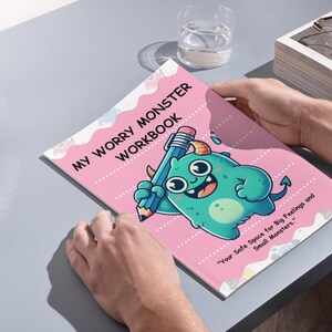 May include: A pink and blue workbook titled "My Worry Monster Workbook" with a cartoon monster holding a pencil. The text below the monster reads "Your Safe Space for Big Feelings and Small Monsters."